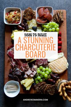 a wooden cutting board topped with lots of different types of cheeses and meats