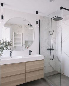 a bathroom with two sinks and a shower