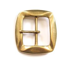 a gold metal buckle with a square shape on the front and side, against a white background