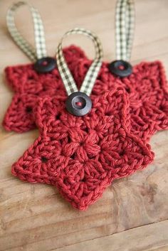 a crocheted star ornament with two black buttons