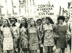 a group of women standing next to each other in front of a sign that reads contra a censura pela cultura