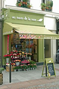 a flower shop on the side of a street