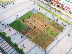 an aerial view of people walking around a large square in the middle of a city