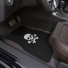 the interior of a car with a skull and crossbones floor mat