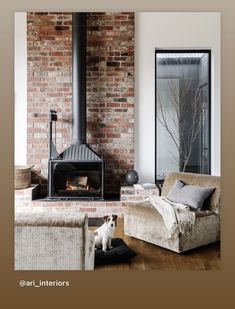 a dog sitting on a pillow in front of an open fire place with brick walls