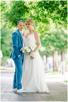 a bride and groom pose for a wedding photo