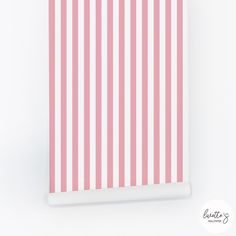 a pink and white striped wall hanging on a wall