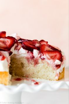 a cake with strawberries is cut in half