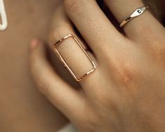 Our simple rings are handcrafted to perfection using the highest quality materials. This Bold Rectangle Ring is a stunning and powerful piece that’s destined to become an everyday favorite. At 1/2"X1”, this rectangle is a sweetly supersized version of our Open Rectangle Ring. The materials are delicate while the rectangular shape itself symbolizes strength. A light hammered texture gives off a glossy sparkle. For a bold design, this rectangle ring is also highly wearable. Select your Bold Rectan Modern Rectangular Ring As A Gift, Modern Rose Gold Rectangular Jewelry, Minimalist Everyday Square Cut Jewelry, Modern Adjustable Rectangular Rings, Adjustable Rose Gold Rectangular Jewelry, Adjustable Rectangular Rose Gold Jewelry, Minimalist Everyday Ring With Rectangular Stone, Minimalist Everyday Rings With Rectangular Stone, Minimalist Rectangular Rings As Gifts