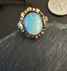 "10K multi gold early 1900s Ring with a colorful natural cabochon Australian Opal(approx 10 by 8mm).  Condition is very good any slight wear commensurate with age-photos show the details.  Size 5, wt.- 2.6 grams, 5/8\" north to south on finger.  Interesting rose gold roses and yellow gold basic setting-A treasure." 1900s Ring, Rose Gold Roses, Gold Roses, Age Photos, Envelope Stamp, Lovely Ring, Australian Opal, Natural Opal, Early 1900s