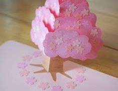 a small tree made out of pink and white paper