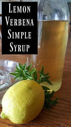 lemon verbbena simple syrup in a glass pitcher next to a lemon on a wooden table