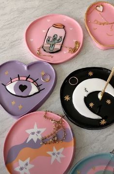 several plates with different designs on them sitting on a table