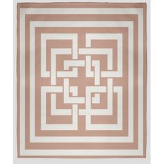 a beige and white area rug with an intertwined design on the top, in front of a white background