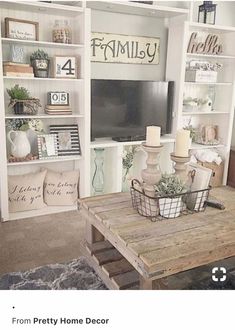 a living room filled with furniture and a flat screen tv sitting on top of a wooden table