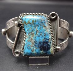 VINTAGE TURQUOISE BRACELET DESCRIPTION:  This old pawn cuff features a breathtaking specimen of high blue Morenci turquoise. Hand applied stamp work graces the sterling/coin silver cuff. This spectacular bracelet will be a cherished addition to your collection of fine vintage Southwestern and Native American jewelry. MEASUREMENTS: Interior of the cuff measures 5 1/2" with an additional 1" slightly adjustable gap. Total circumference:  6 1/2" Measures 2 3/8" straight across the widest part  (from Jewelry Measurements, Morenci Turquoise, Bones Bracelet, Cowgirl Jewelry, Turquoise Bracelet Cuff, Turquoise Cuff, Vintage Turquoise, American Jewelry, Native American Jewelry