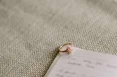 a wedding ring sitting on top of a piece of paper