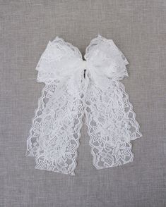 "Oversized vintage lace hair bow will be a charming addition for any outfits. Perfect for wedding, communion, birthday parties or any special events. Tulle bow is attached on grosgrain fabric bow on alligator clip. DETAILS: Colors available: White Bow Size: L 3.75\" x W 1.5\" Tail Length: 8\" Handmade in the USA" Communion Hair, Lace Hair Bow, Wedding Communion, Communion Hairstyles, Hair Accessories Flower, Tulle Bow, White Bow Tie, Lace Accessories, Tulle Bows