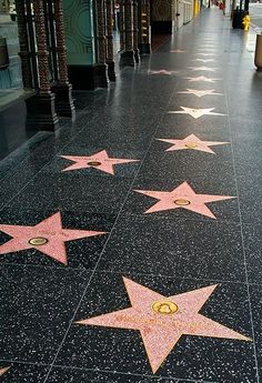 a woman writing on the hollywood walk of fame