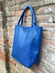 Large tote leather bag in COBALT BLUE. Shopper bag. Blue color natural GENUINE leather. Large enough for books or a laptop, tablet, cosmetics bag etc. Blue leather shopper. Carry all strong leather bag. Cobalt blue laptop or book bag. The inside of the bag is not lined (although properly finished!) . We added a small leather pouch attached by a chain. Zipper at the top. Excellent quality soft but strong genuine leather. Width upper part: 41cm - 16 inch Height: 35 cm - 14 inch Base: 16 cm x 23 cm Modern Blue Satchel For Everyday Use, Blue Double Handle Shoulder Bag For Everyday, Everyday Blue Double Handle Bag, Modern Blue Bag For Everyday Use, Blue Satchel Shoulder Bag For Everyday, Modern Blue Bag For Everyday, Blue Double Handle Everyday Shoulder Bag, Blue Everyday Double Handle Shoulder Bag, Everyday Blue Rectangular Bag