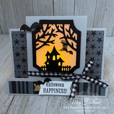 a handmade halloween card with a black and white background, featuring a silhouette of a house