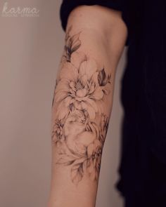 a woman with a flower tattoo on her arm