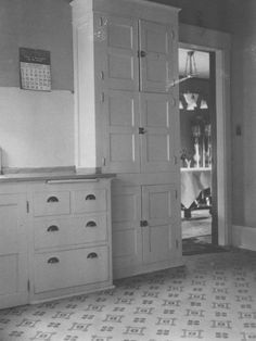 an old black and white photo of a kitchen