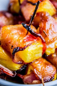 bacon and pineapple skewers in a white bowl