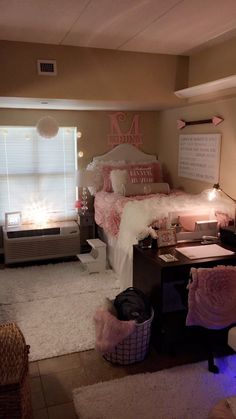 a bedroom with pink and white decor on the walls, carpeted flooring and bedding