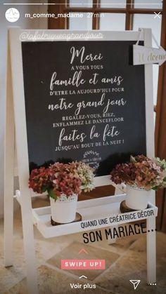 a sign with some flowers on it and the words in french are written below them