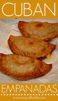 three empanadas sitting on top of a white table cloth with the words cuban written below it