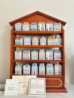 a wooden shelf filled with lots of little houses