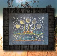 a cross - stitch pattern with flowers and birds in the sky on a blue background