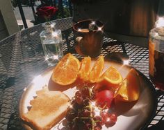 a plate topped with toast and fruit on top of a table