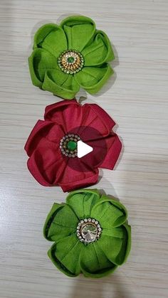 three green and red flowers on a table