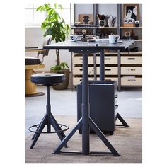 a table with two stools in front of it and an office desk behind it