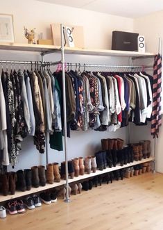 an organized closet with lots of clothes and shoes