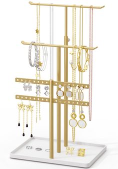 a gold jewelry rack with several pairs of earrings on it