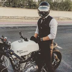 a man standing next to a parked motorcycle