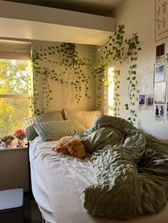 an unmade bed in a bedroom with plants growing on the wall