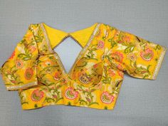 Buy a beautiful yellow color Indian saree designer blouse with floral print. You can pair up with any Indian Saree for any occasion to make your look elegant. A yellow multicolor floral blouse is a woven design padded saree blouse that has a V neck,  a beautiful back, and hook closure. You can pair it with any Indian Saree, Banarasi Silk Sarees, and Chanderi Silk sarees. Buy it from Pure Elegance sari blouse from Pure Elegance Indian clothing store in the USA.- Front View Fitted Chanderi Blouse Piece With Floral Print, Yellow Chanderi Blouse For Puja, Multicolor Floral Print Blouse For Designer Wear, Festive Yellow Chanderi Blouse, Fitted Floral Chanderi Blouse Piece, Yellow Unstitched Blouse With Cutdana Details, Yellow Zari Work Blouse For Puja, Yellow Unstitched Chanderi Blouse, Designer Chanderi Blouse Piece With Floral Print