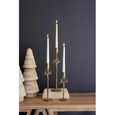 three candles are sitting on a wooden table