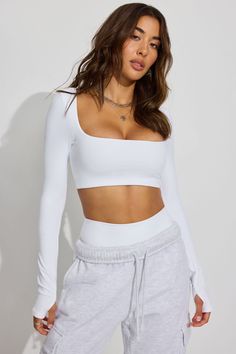 Activewear game unmatched. Features - Square scoop neckline - Removeable pads at bust - Logo bonded at back - Very stretchy! - Double lined Size & Fit - Fit: Fitted - Length: Cropped - Model is wearing size S Materials & Care - Content: 75% nylon, 25% spandex - Care: Machine wash, cold - Imported Garage Clothes, White Tops Outfit, Garage Clothing, Gym Fits, Black Activewear, Denim Outfit, Workout Wear, Christmas List, Scoop Neckline