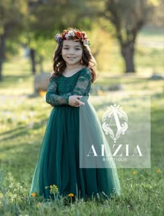 This stunning emerald green flower girl dress is truly a showstopper. The dress features a scallop V back design, adding a touch of elegance and sophistication to the overall look. The long sleeves are perfect for cooler weather or evening events, while the soft lace and tulle bottom adds a touch of whimsy and charm. The dress is fully lined for comfort and coverage, ensuring that your little flower girl will feel comfortable and confident all day long. The emerald green color is rich and vibrant, making it a perfect choice for fall or winter weddings. The dress is made from the softest materials, ensuring that your flower girl will feel like a princess as she walks down the aisle. Overall, this emerald green flower girl dress is a stunning choice for any special occasion. With its beautif Emerald Green Toddler Dress, Dark Green Flower Girl Dresses, Flower Girl Dresses Green, Emerald Green Flower Girl Dress, Winter Flower Girl Dresses, Winter Flower Girl Dress, Green Flower Girl Dress, Fall Flower Girl Dresses, Green Flower Girl Dresses