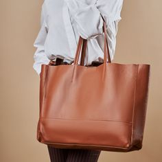 A highly functional holdall, this leather tote will carry all your essentials throughout the day. Boasting a soft, leather in a gorgeous deep color tone, complete with sturdy leather handles and an inner zip pocket for added security. Handmade in Italy 100% from NATURAL genuine leather The bag comes with a small pouch on the inner part of the bag (zipper), and without any linings fabrics (natural leather lining). Professional craftsmanship and excellent quality, soft touch but strong genuine leather! Width: 17.7 inch / 45cm Height: 13.9 inch / 35,5cm Depth: 3.9 inch / 10cm Standard handles height: 8.6 inch/22 cm Weight: 10oz / 300grams FEATURES -Inside zip pocket -Inside leather slots -Padded leather handles -Suede raw interior lining -Easy hand and shoulder carrying -Italian materials & w Leather Tote Weekender Bag For On-the-go, Cognac Textured Leather Bag For On-the-go, Versatile Tote Shoulder Bag With Smooth Grain, Versatile Cognac Bag With Smooth Grain, Versatile Smooth Grain Tote Shoulder Bag, Soft Leather Tote Travel Bag For On-the-go, Smooth Grain Tote Hobo Bag For Work, Smooth Grain Hobo Bag Tote For Work, Smooth Grain Hobo Bag In Tote Shape For Work