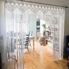 an open living room door with sheer curtains