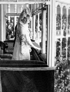 a black and white photo of a woman in a wedding dress