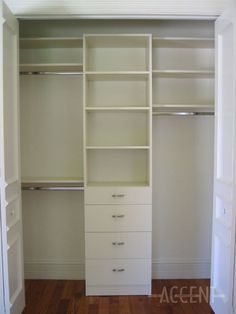 an empty walk in closet with white shelves and drawers