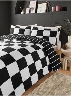 a black and white checkered comforter set on a bed with two side tables