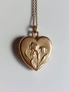 Lovely Antique Iris Locket from the Art Nouveau era. It opens to a sliding beveled glass, meant to protect the photos that the owner would insert inside. The locket has a heart shape and depict an iris flower in a repousse style. The iris flower was named after the Greek goddess Iris, due to the variety of colors it can have, blue, purple, orange, yellow, white... Indeed Iris is the messenger of the Olympians Gods and make the junction between the Earth and the Sky, by means of a rainbow. Details: The pendant is from the Art Nouveau era, 1880-1910. It is not stamped and I believe made of a gold plated metal.  Condition: The locket is in good Antique condition, with some trace of wear. There is some gold plating loss here and there, in particular on the flower, and one dent at the back, ple Antique Heart Locket, Olympians Gods, Goddess Iris, Art Nouveau Iris, Iris Heart, Iris Jewelry, The Olympians, Iris Flower, Jewelry Accessories Ideas